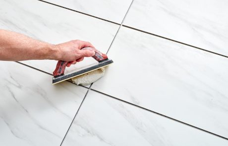 man applying grout to tile - how to choose the right grout